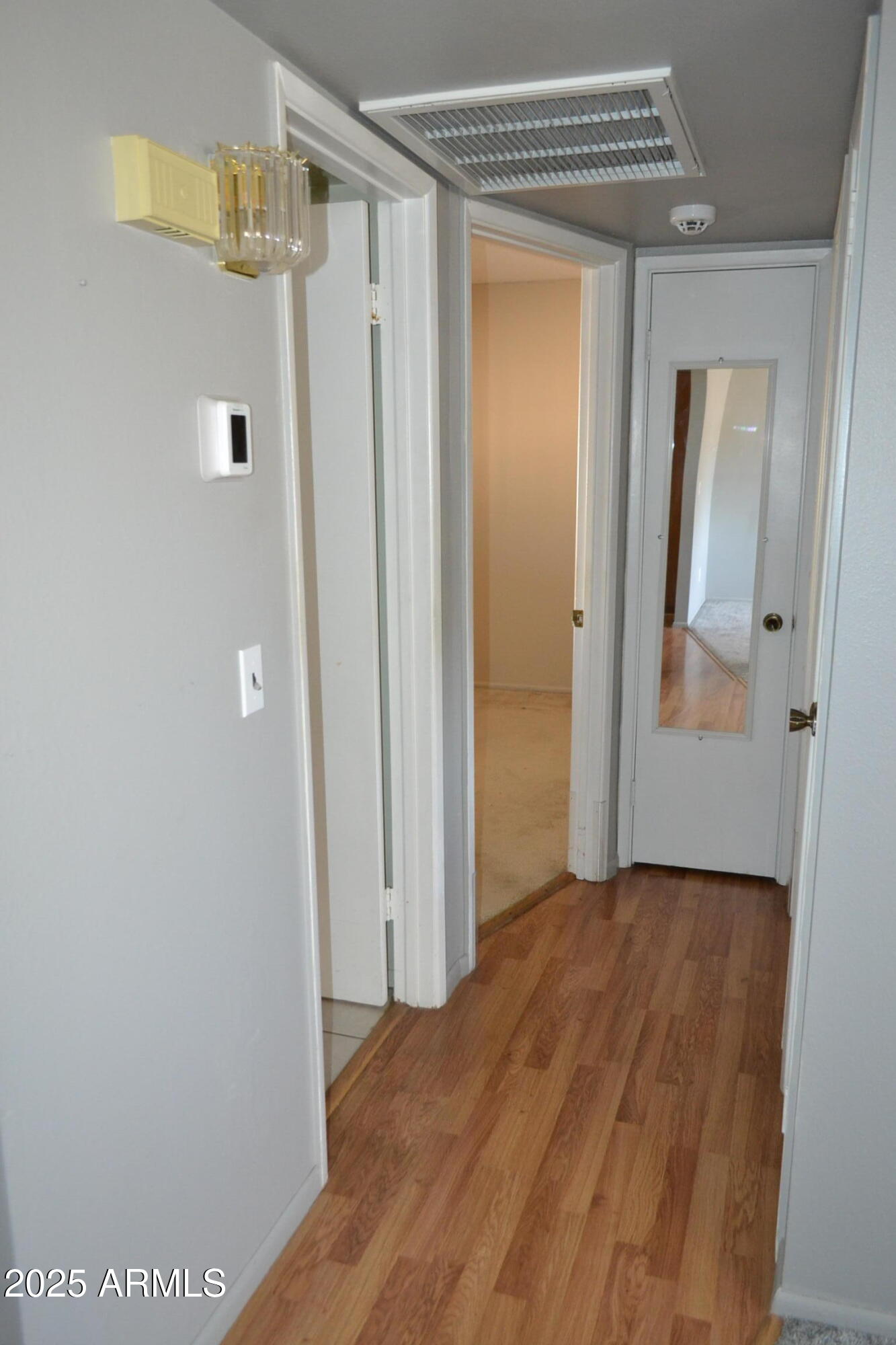 1710 West 13th Avenue Apache Junction, AZ 85120 - Photo 11 of 24 a view of a hallway with wooden floor