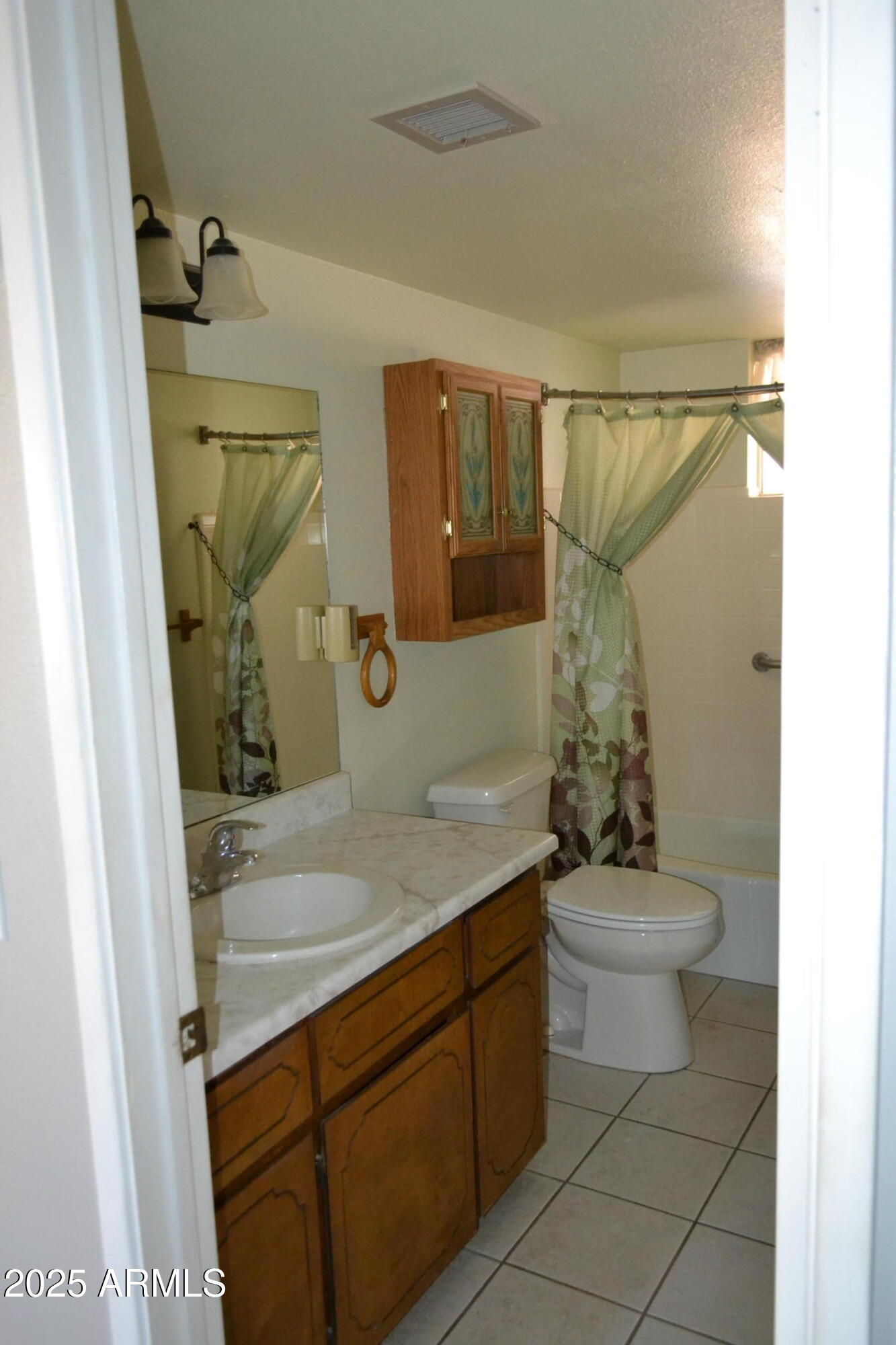 1710 West 13th Avenue Apache Junction, AZ 85120 - Photo 14 of 24 a bathroom with a granite countertop sink mirror vanity and toilet