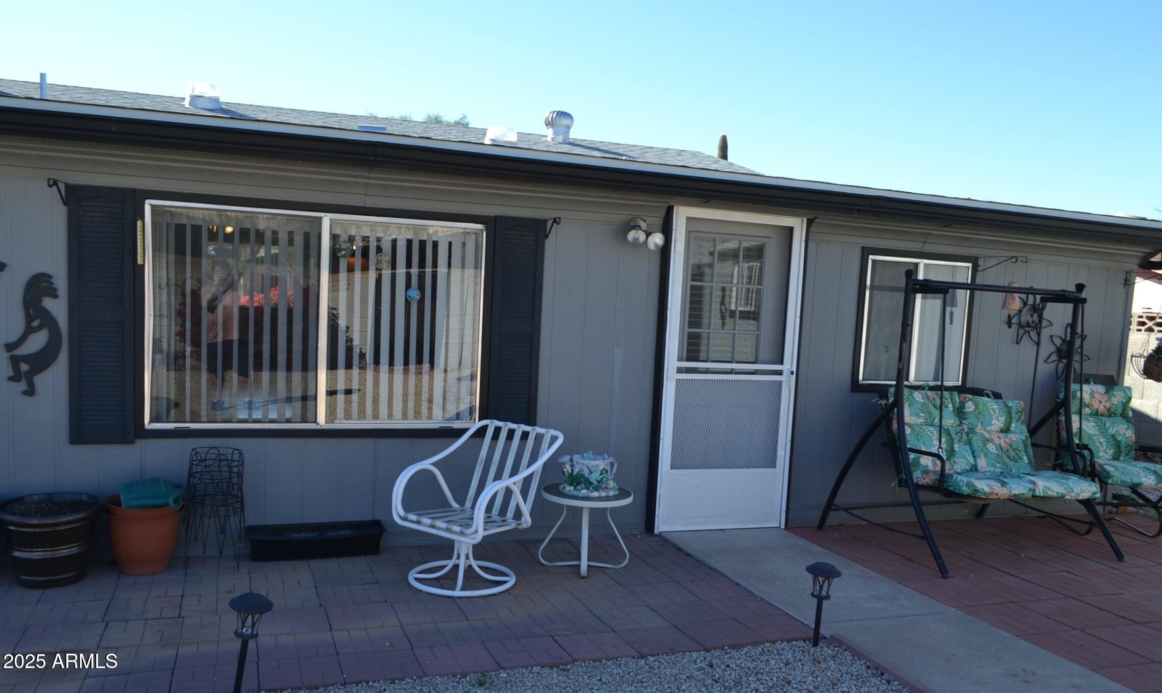 1710 West 13th Avenue Apache Junction, AZ 85120 - Photo 21 of 24 a front view of a house with patio