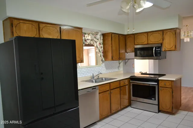 a kitchen with a sink and a refrigerator