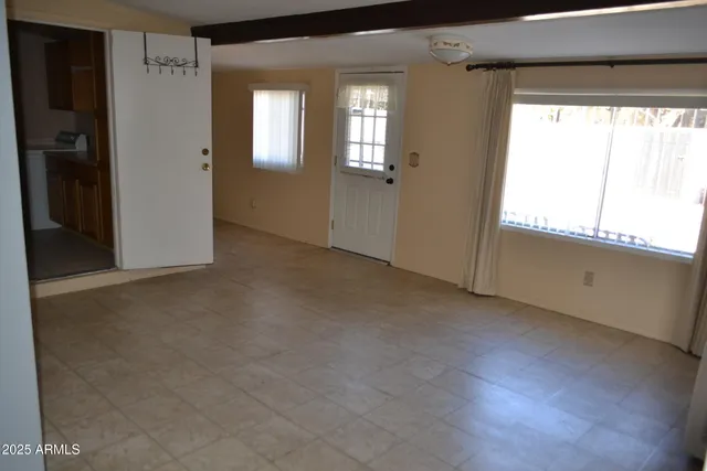 a view of an empty room with a window