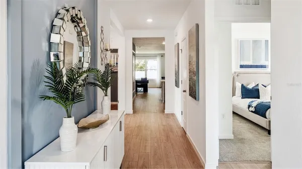 a kitchen with stainless steel appliances a stove a sink a microwave a refrigerator a stove a dining table and chairs