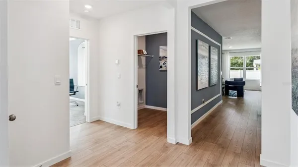a large white kitchen with a large window