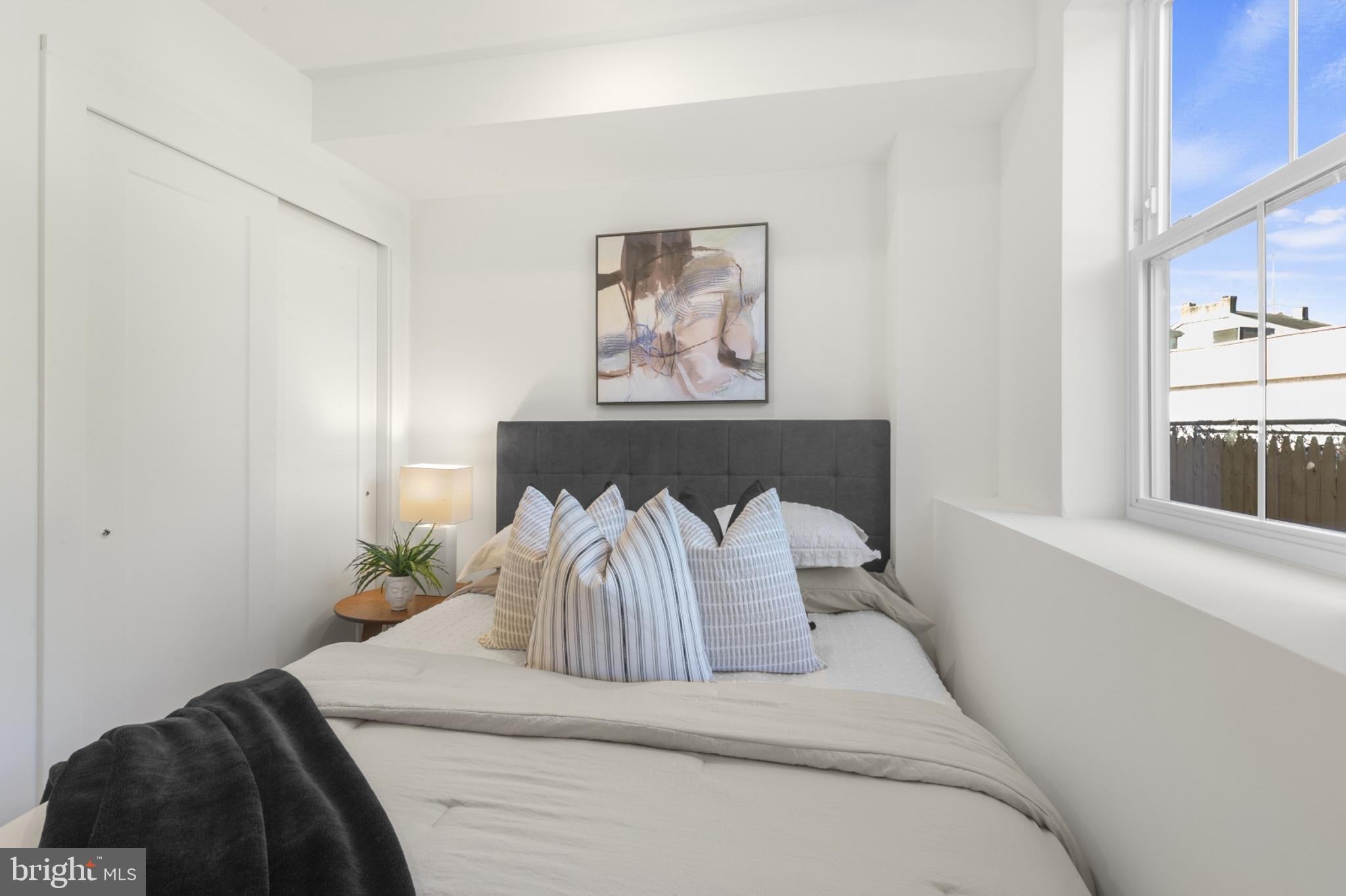 7037 Ridge Avenue, Unit 103 Philadelphia, PA 19128 - Photo 14 of 19 a bedroom with a bed and window