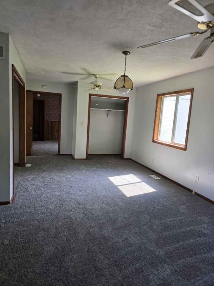 1406 Searle Drive Normal, IL 61761 - Photo 11 of 11 an empty room with windows and cabinet