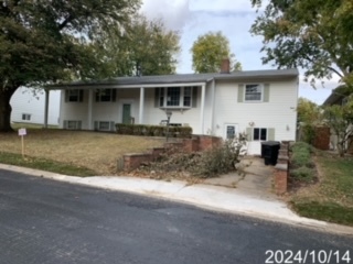 1406 Searle Drive Normal, IL 61761 - Photo 2 of 11 a front view of a house with a garden and trees