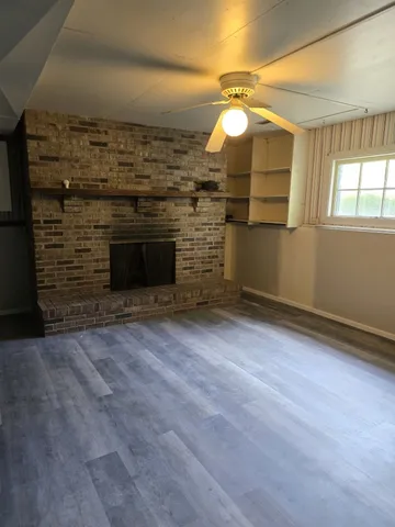 wooden floor in an empty room with a fireplace
