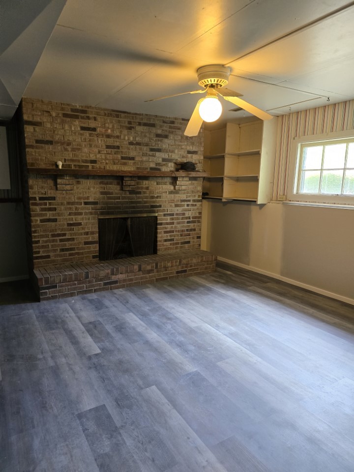 1406 Searle Drive Normal, IL 61761 - Photo 4 of 11 wooden floor in an empty room with a fireplace