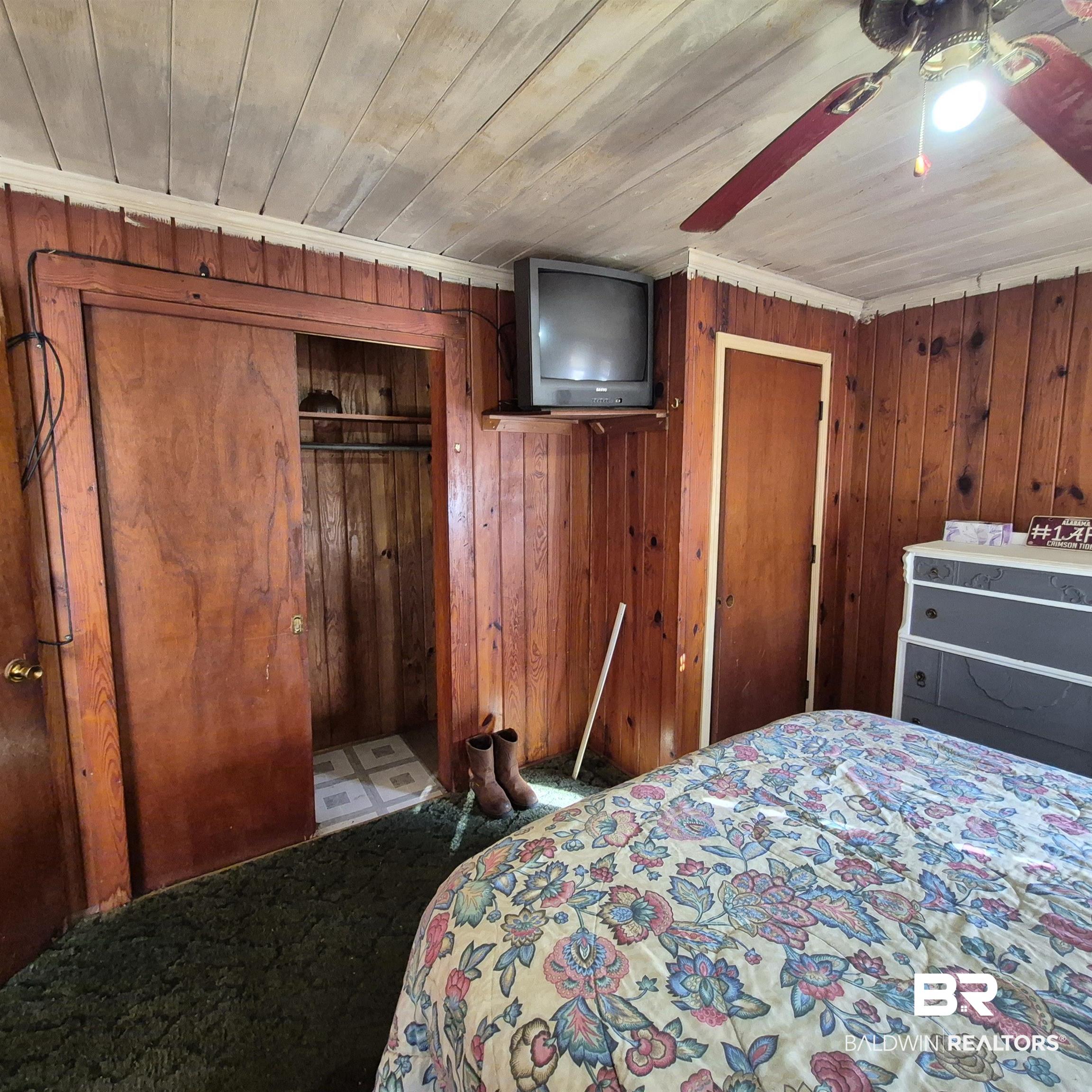 320 Bruner Avenue Evergreen, AL 36401 - Photo 6 of 15 Bedroom with a closet, wood walls, ceiling fan, and wooden ceiling