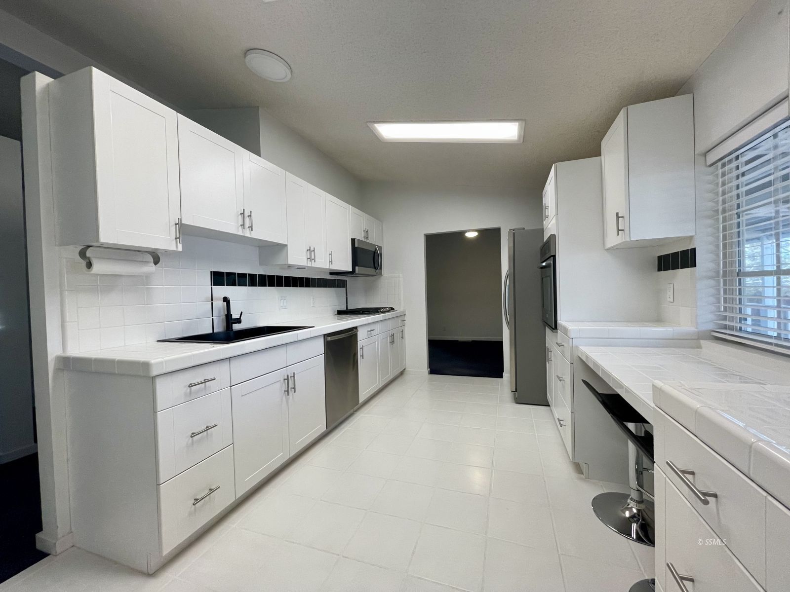 1449 Dunes Street Ridgecrest, CA 93555 - Photo 8 of 50 a kitchen with granite countertop white cabinets and white appliances
