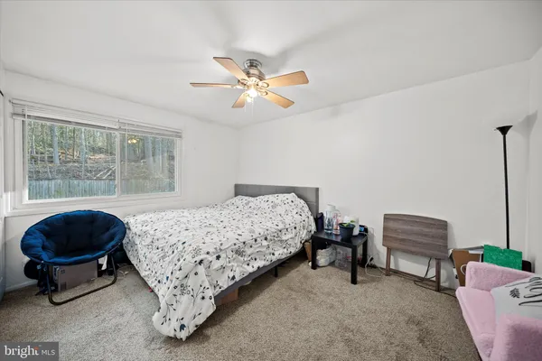 a bedroom with a bed and a chair