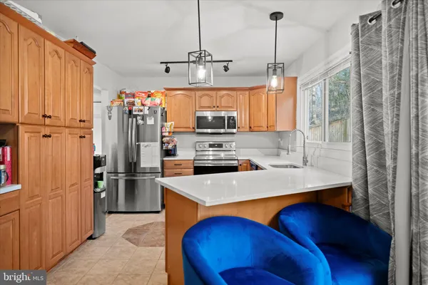 a kitchen with refrigerator and window