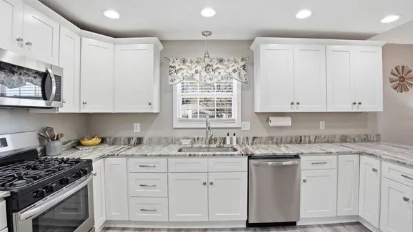 a kitchen with a sink stove and cabinets