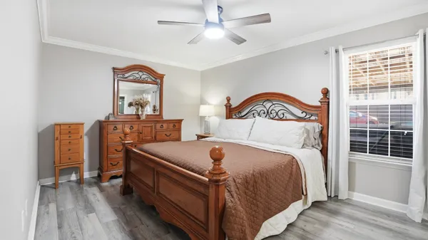 a bedroom with a bed and a chandelier