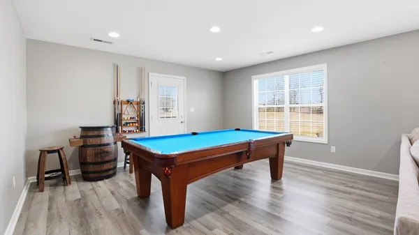 a room with furniture and pool table