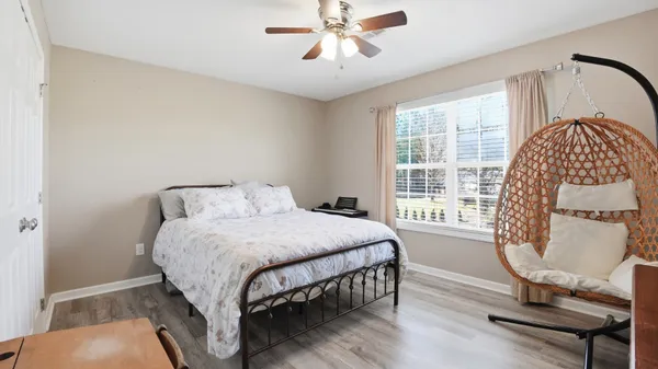 a bedroom with furniture and a flat screen tv