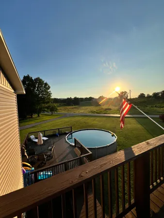 a backyard of a house with table and chairs