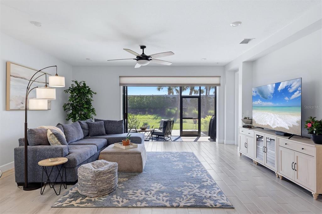 9268 Tequila Sunrise Drive Sarasota, FL 34241 - Photo 10 of 56 a living room with furniture and a flat screen tv
