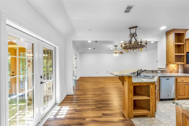 a view of a kitchen with a sink and cabinets