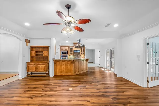 a living room with fireplace furniture and a ceiling fan