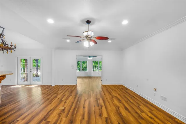 a view of empty room with wooden floor