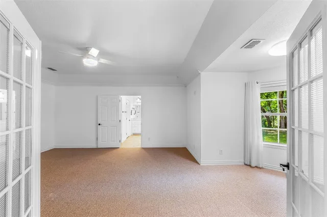 an empty room with windows and closet