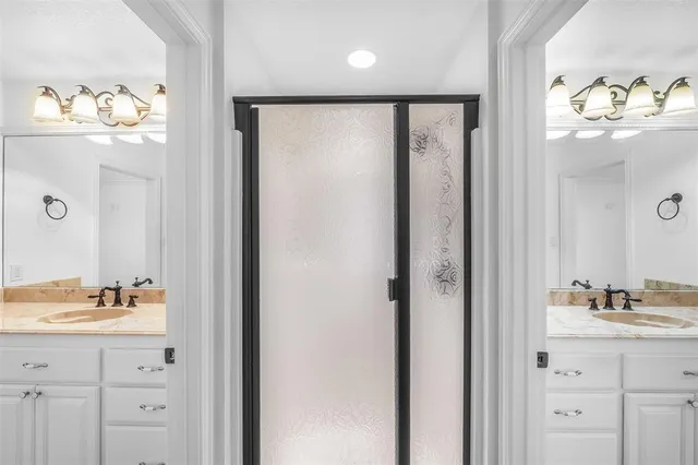 a bathroom with a mirror sink and vanity