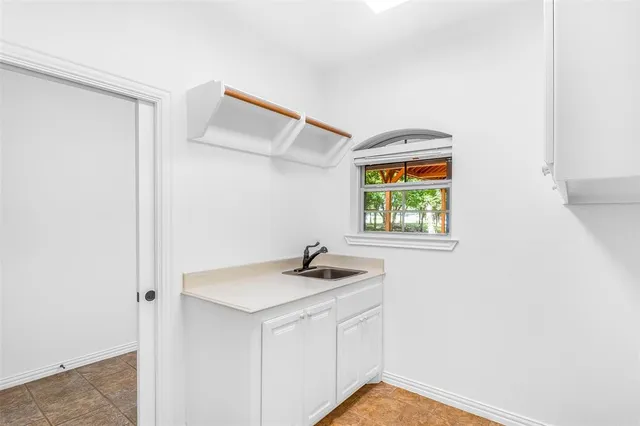 a bathroom with a sink and a window