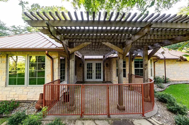 a view of a house with a chairs and table in a patio