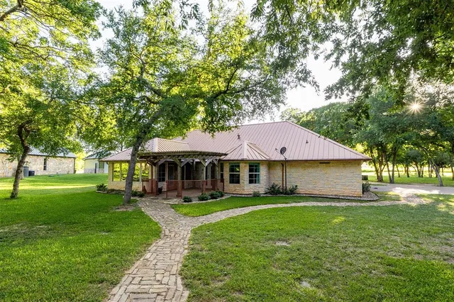 a house view with a sitting space and garden
