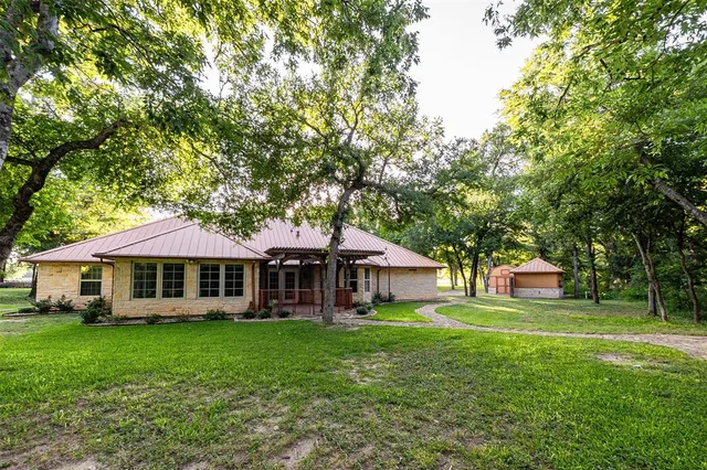 a front view of a house with a yard table and chairs