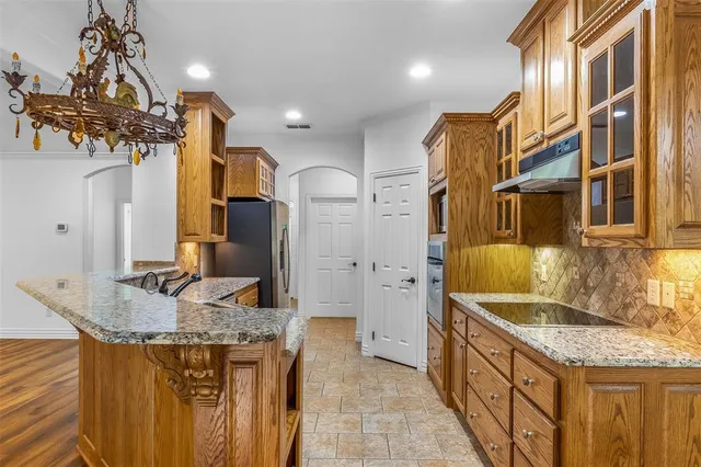 a bathroom with a granite countertop sink a mirror and shower