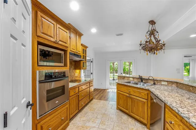 a kitchen with stainless steel appliances granite countertop a sink and stove