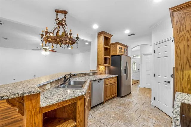 a kitchen with stainless steel appliances granite countertop a sink stove and refrigerator