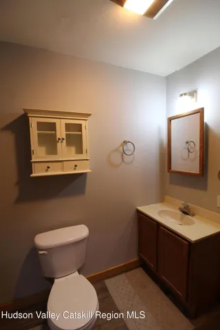 a bathroom with a toilet sink and mirror
