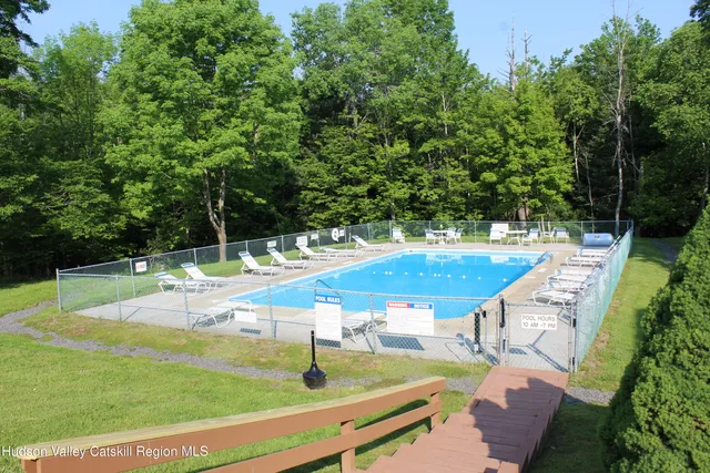 a view of a backyard with swimming pool