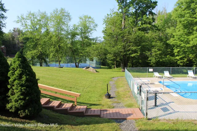 a view of a swimming pool and lounge chairs