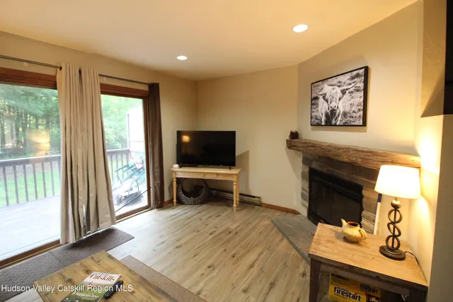 a view of a livingroom with furniture and a flat screen tv