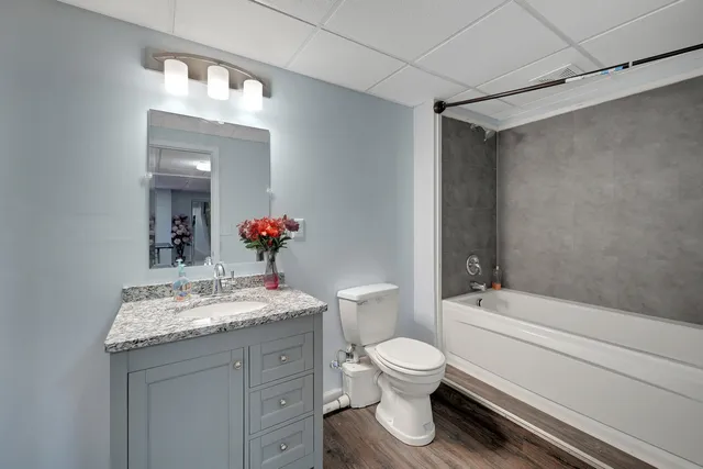 a bathroom with a sink toilet and shower