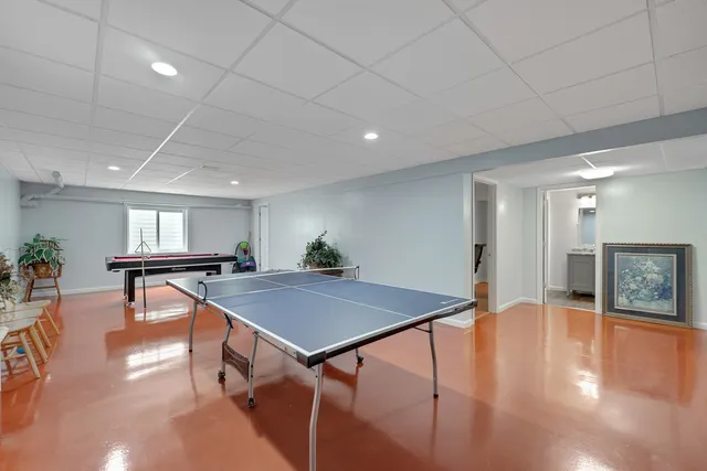 a room with lots of table tennis table and chairs