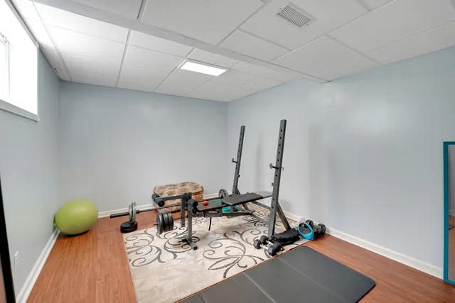 a room with chairs and wooden floor