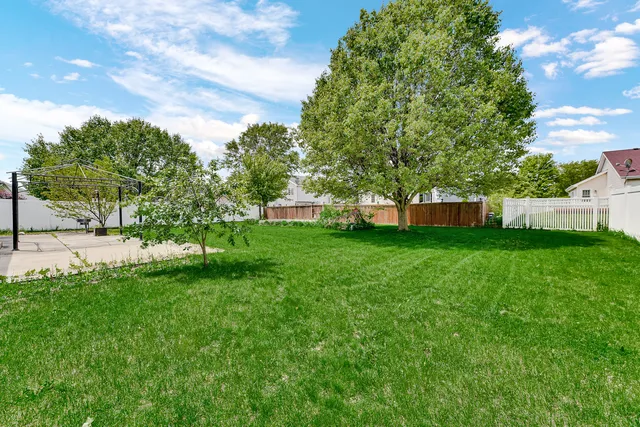 a view of a house with a backyard