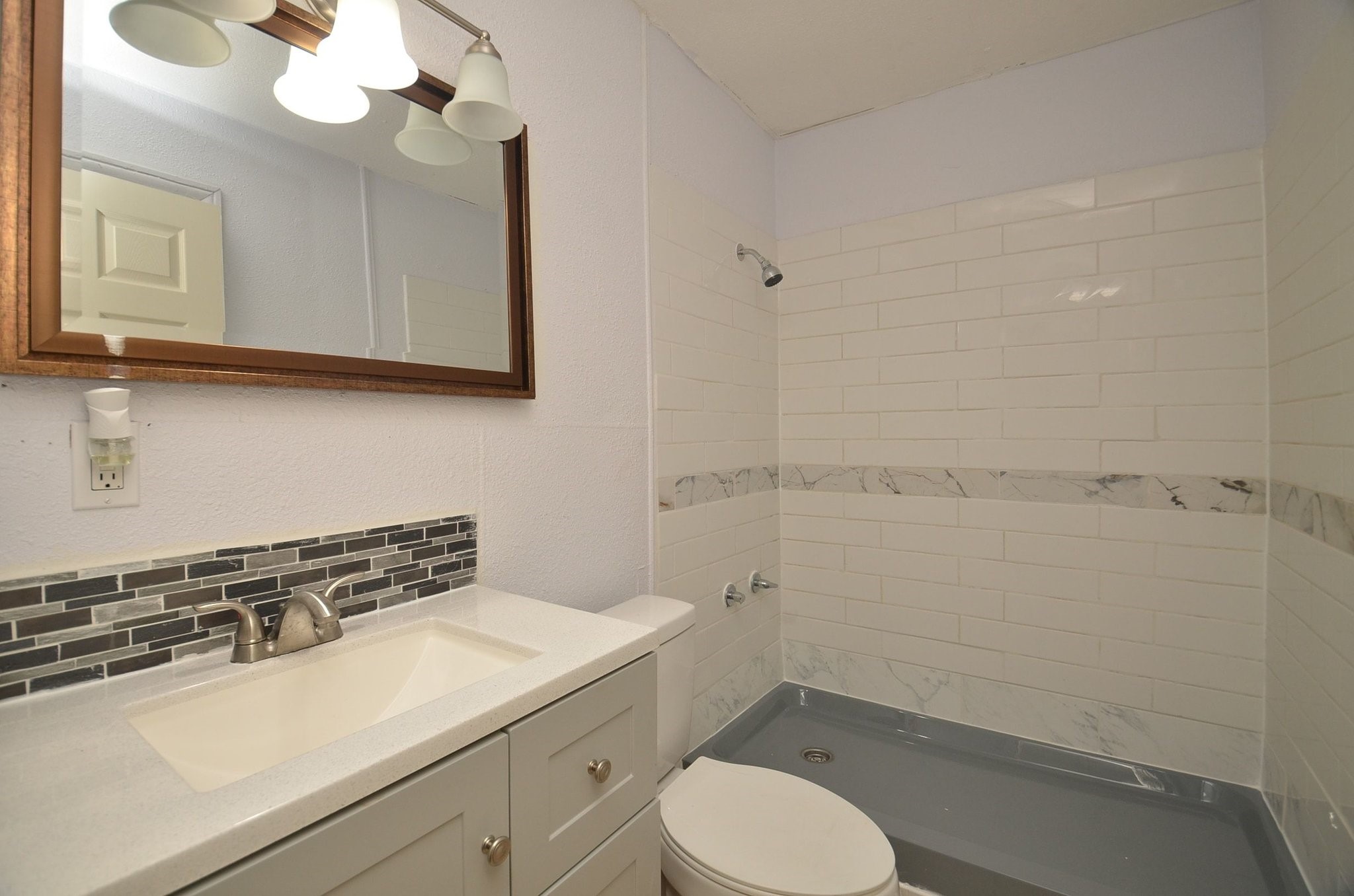 1600 5th Street Rosenberg, TX 77471 - Photo 19 of 24 Full bathroom with updated vanity and decorative mirror.