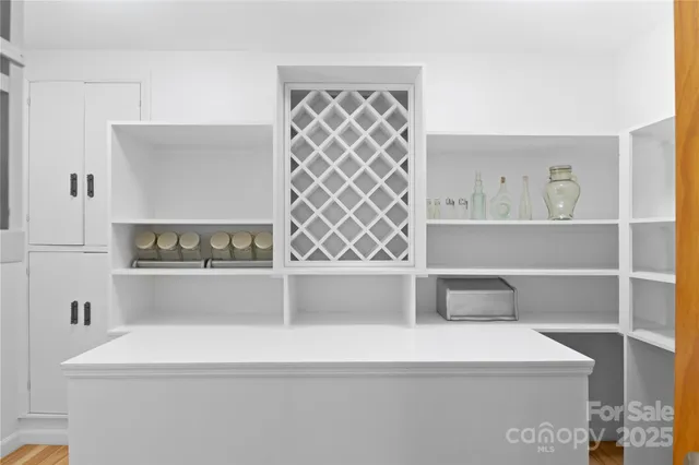 a bedroom with a bed and a flat tv screen on dresser