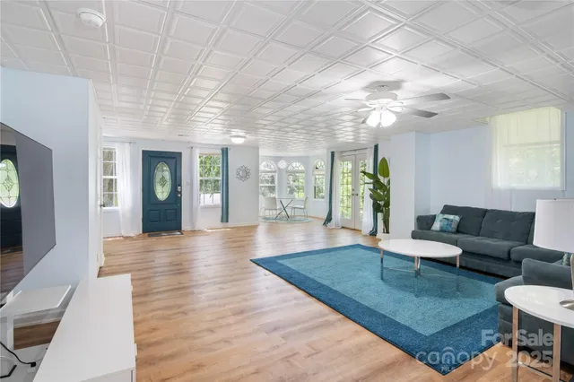 a view of a dining room with furniture large windows and wooden floor