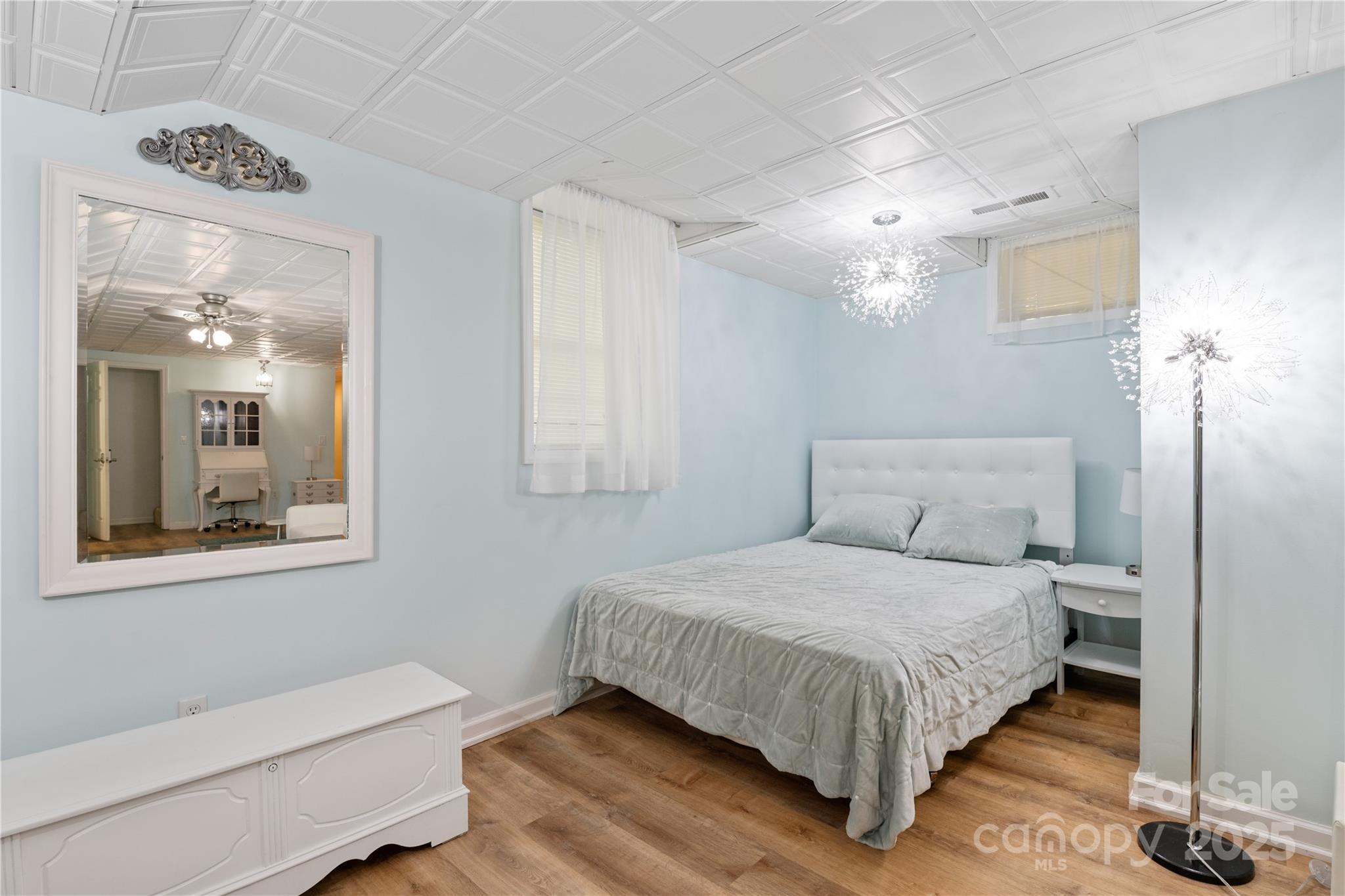 3 Northwood Road Asheville, NC 28804 - Photo 33 of 48 a bedroom with a large bed chandelier and a window