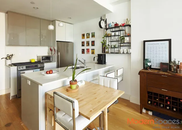 a kitchen with a stove a refrigerator and a dining table