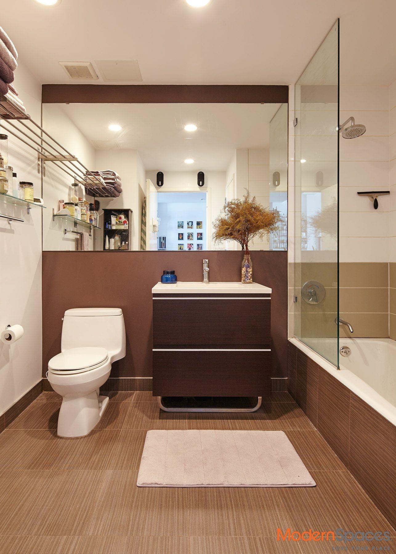 2-26 50th Avenue, Unit 9C Queens, NY 11101 - Photo 4 of 10 a bathroom with a sink a toilet and a shower