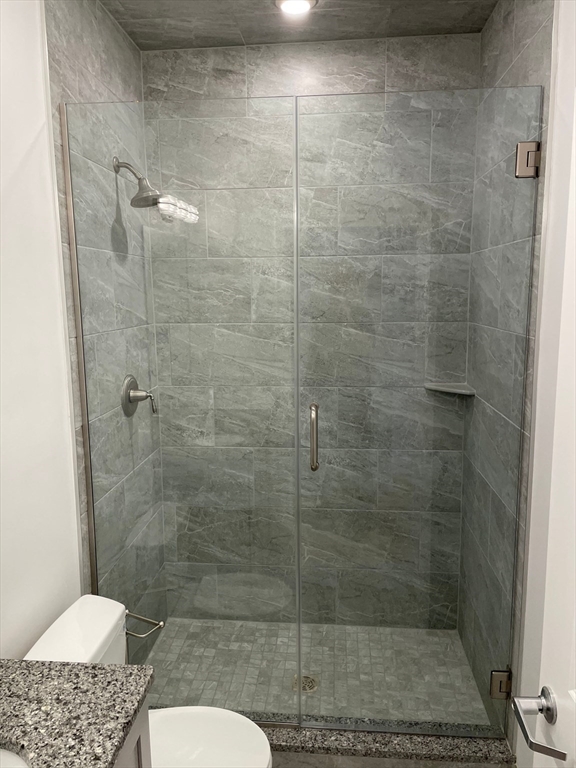 64 Market Street, Unit 406 Lynn, MA 01901 - Photo 4 of 10 a bathroom with a shower and a toilet