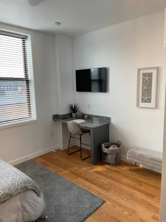 a bedroom with furniture and a wooden floor
